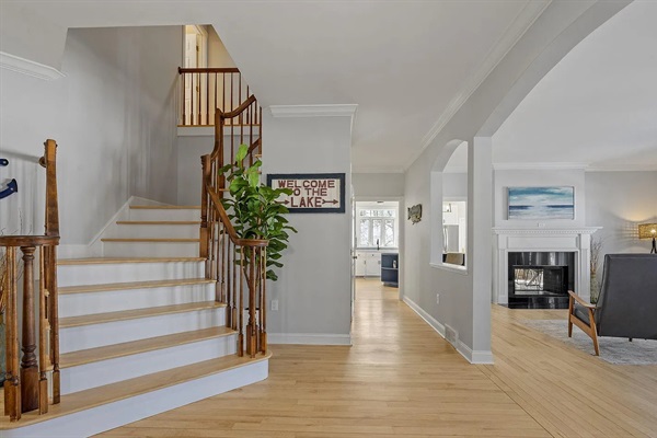 Your first impression says it all - a beautiful winding staircase, open living room, and panoramic lake views greet you upon arrival.