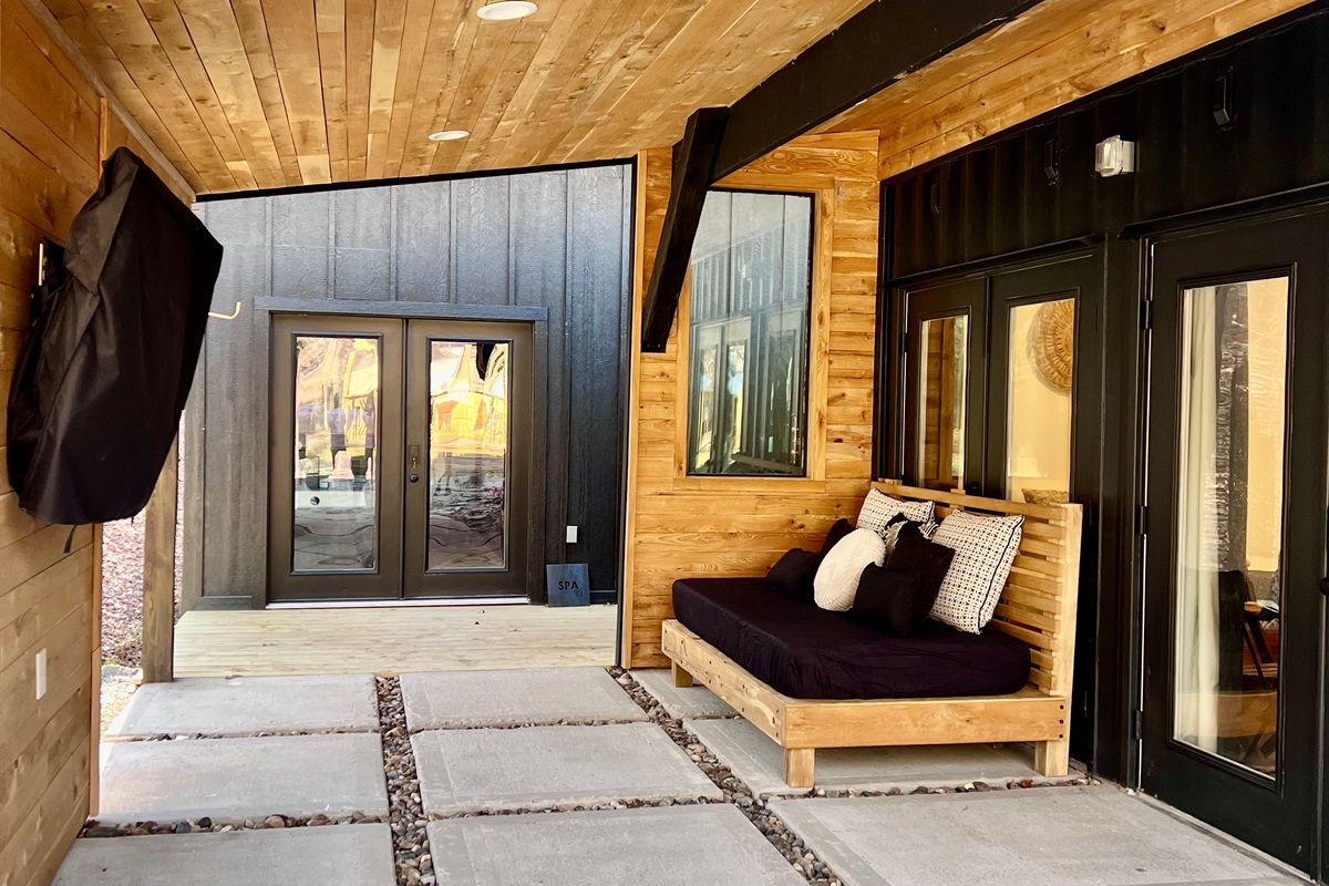Outdoor patio with day bed and T.V.