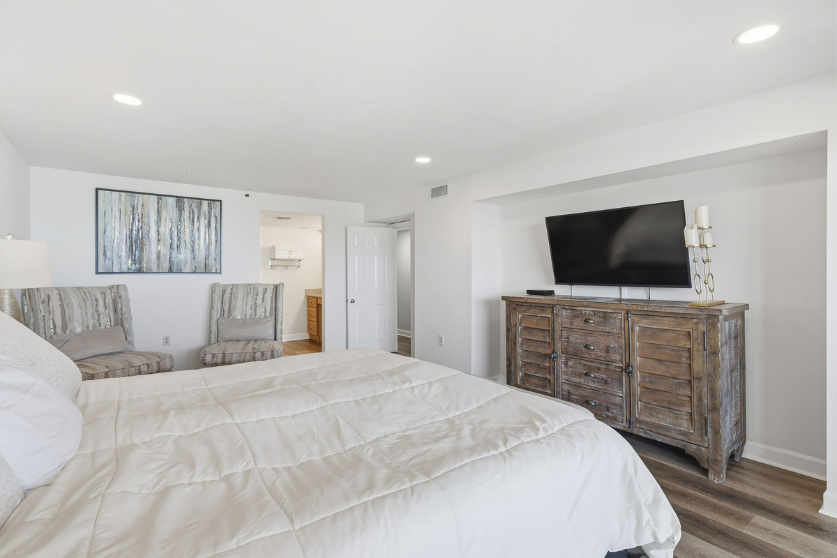 Primary bedroom dresser and wall-mounted TV