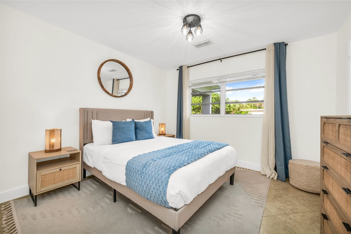 2nd Bedroom: A bright and welcoming retreat featuring a plush queen bed, soft layered linens, and coastal-inspired décor. This room offers ample storage, warm natural light, and a peaceful atmosphere perfect for a restful night’s sleep.