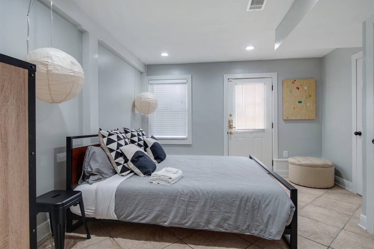 Bedroom 2.  King bed. En-suite bathroom. Exterior door.  (Not pictured: Roku TV.)