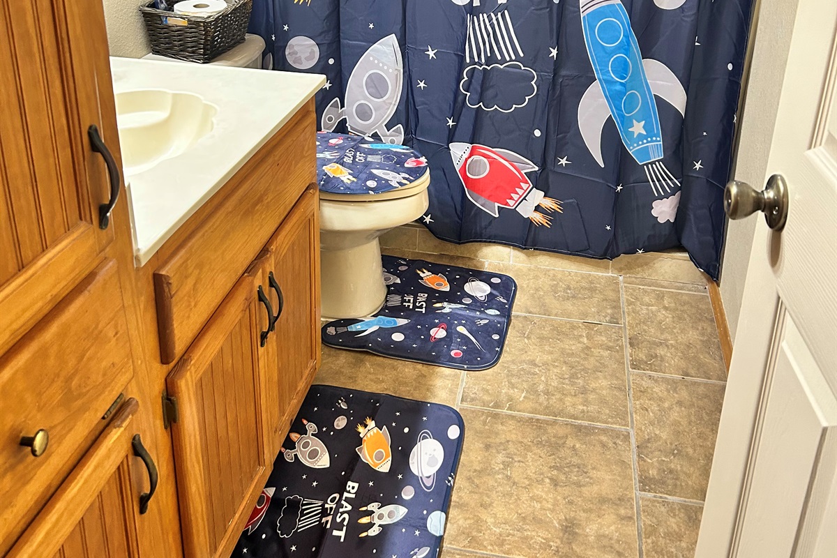 Ground floor bath servicing the bunk room and pool areas with walk-in shower with bath toiletries provided. 