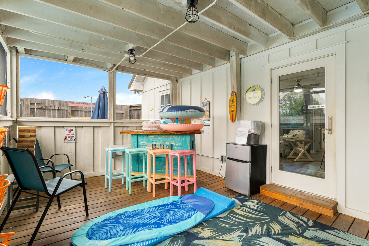 Covered hot tub, dartboard, sunroom interior