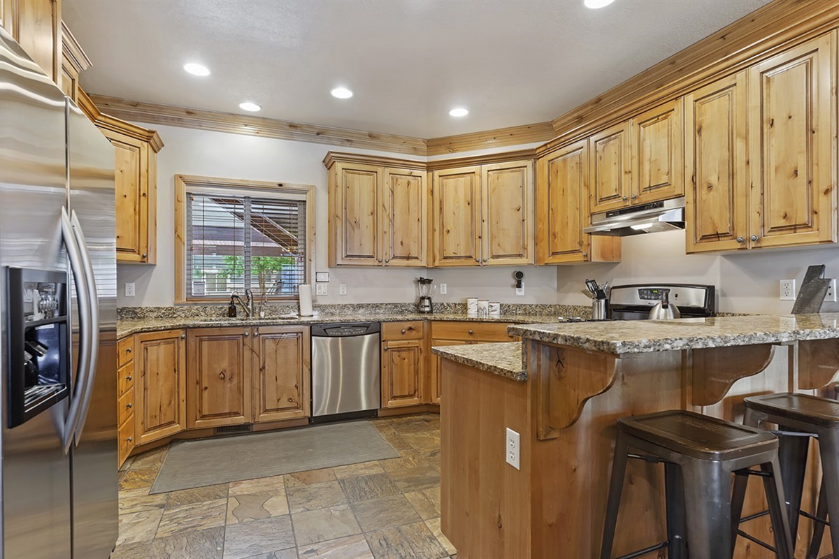 Fully stocked kitchen with bar seating—ideal for casual dining and morning coffee.