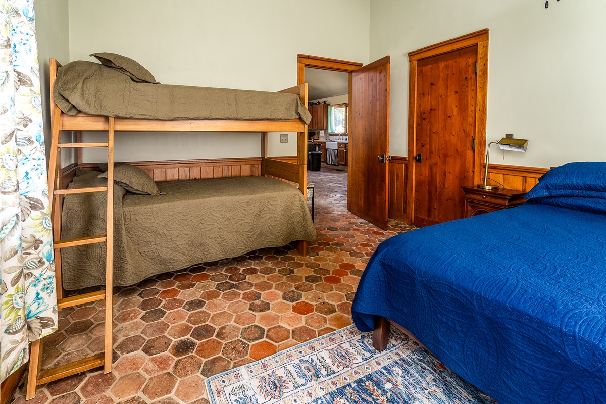 Main bedroom with a king bed and twin bunk beds—perfect for families or extra guests.