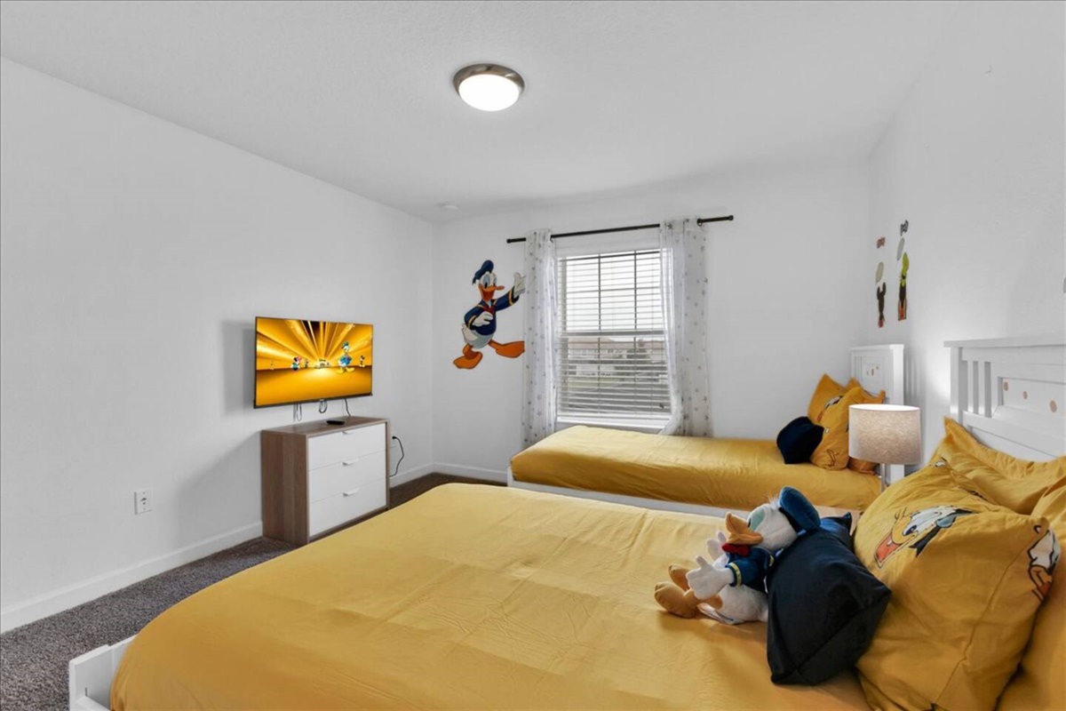 The Donald Duck bedroom has a single and a double bed, plus a TV for the little ones to watch their favorite shows on vacation!