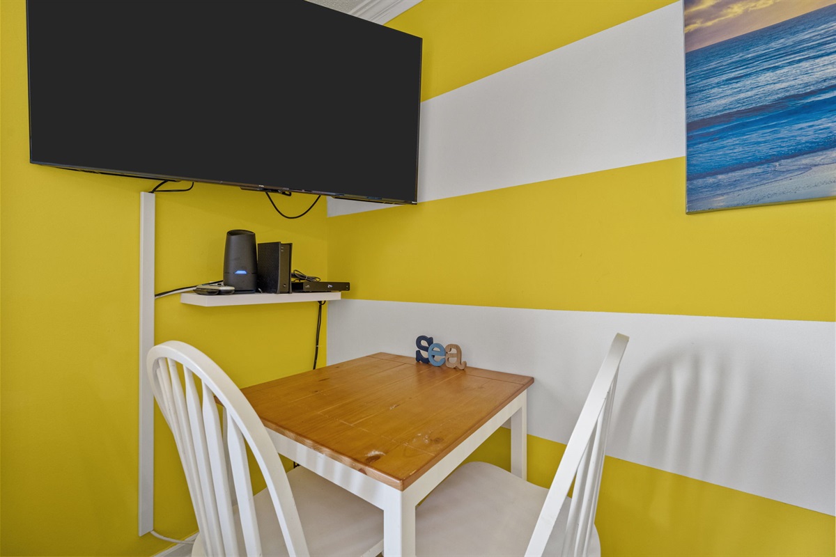 Compact dining space with TV nearby, great for casual meals or a relaxed movie night