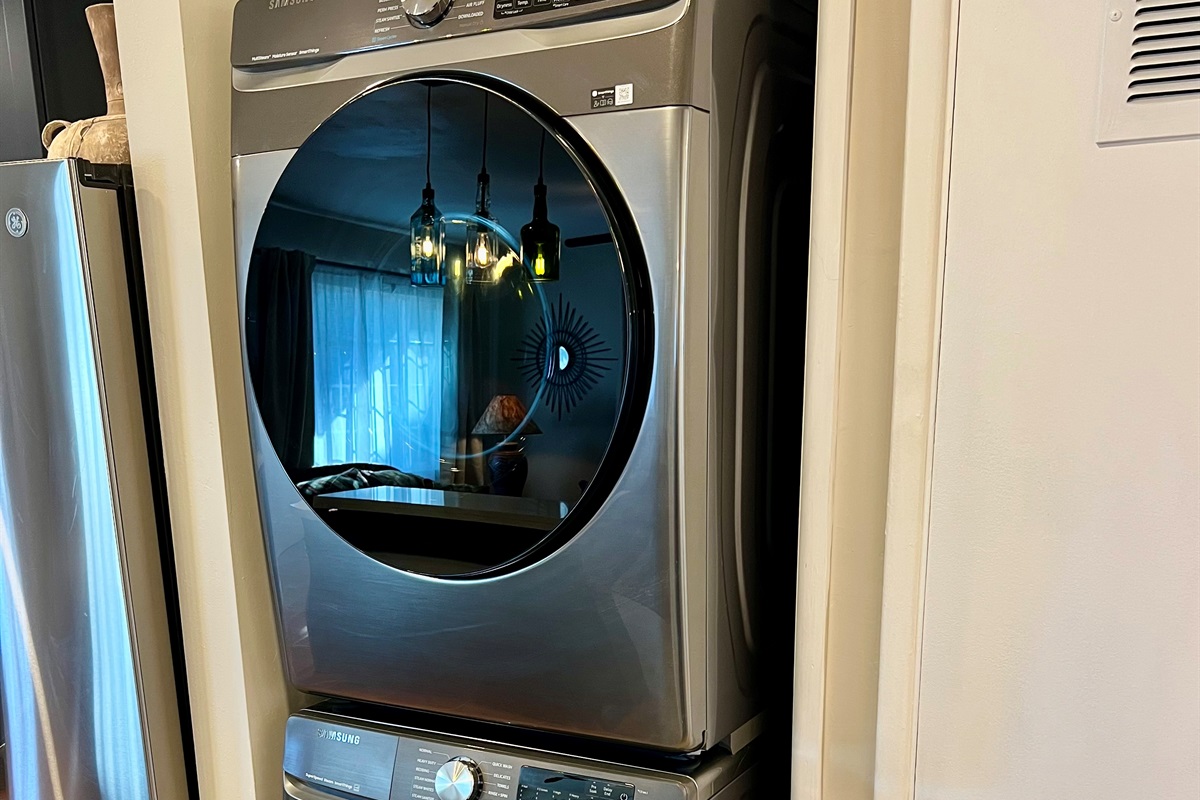 Enjoy the convenience of an in-unit, stacked washer and dryer, located just off the rustic dining area and open-plan living room.