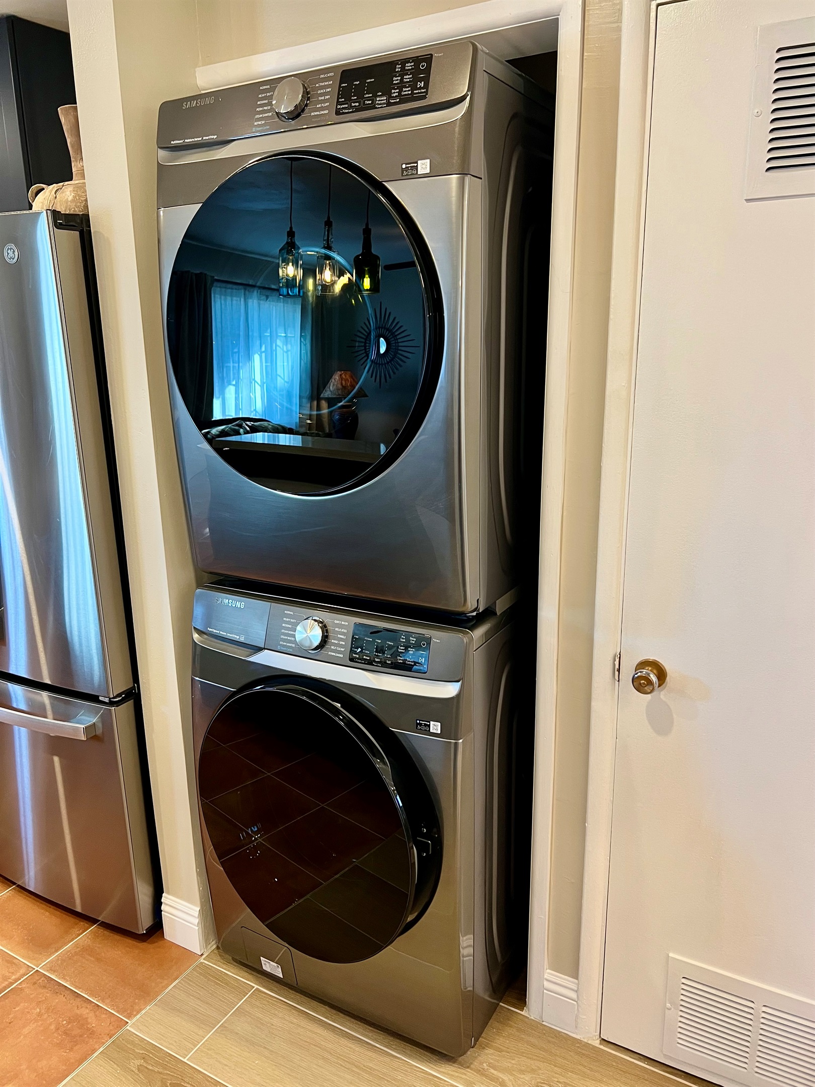 Enjoy the convenience of an in-unit, stacked washer and dryer, located just off the rustic dining area and open-plan living room.