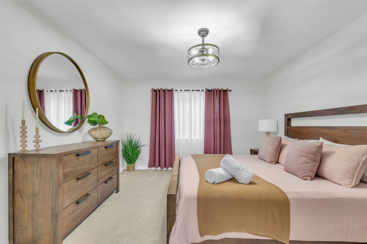 Warm and bright! Master suite with pink bedding and modern comfort