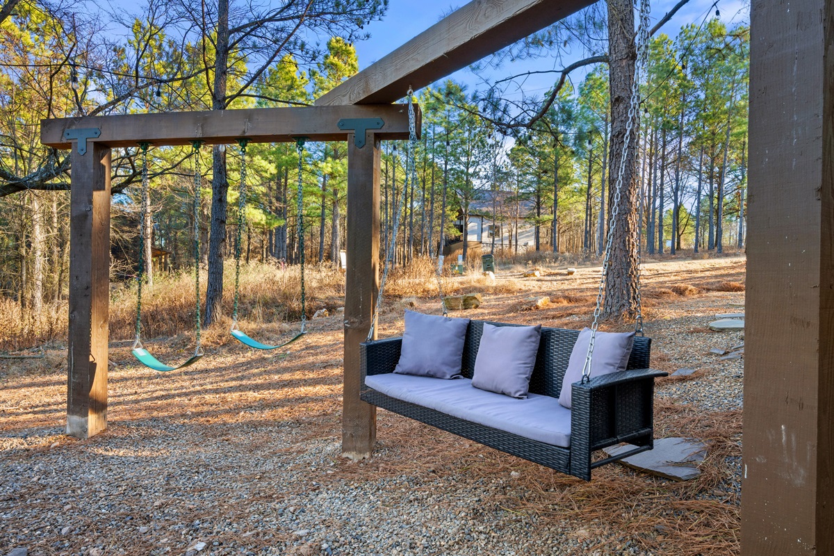 This outdoor lounge space is a great place to sit, relax, and enjoy the wooded surroundings while the kids play or the grill heats up.