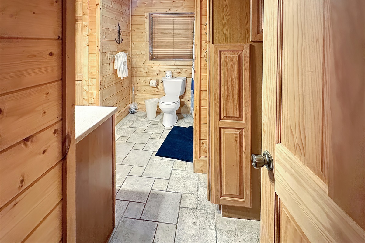 Bathroom 1: Enjoy rustic charm and modern amenities in this inviting bathroom oasis!