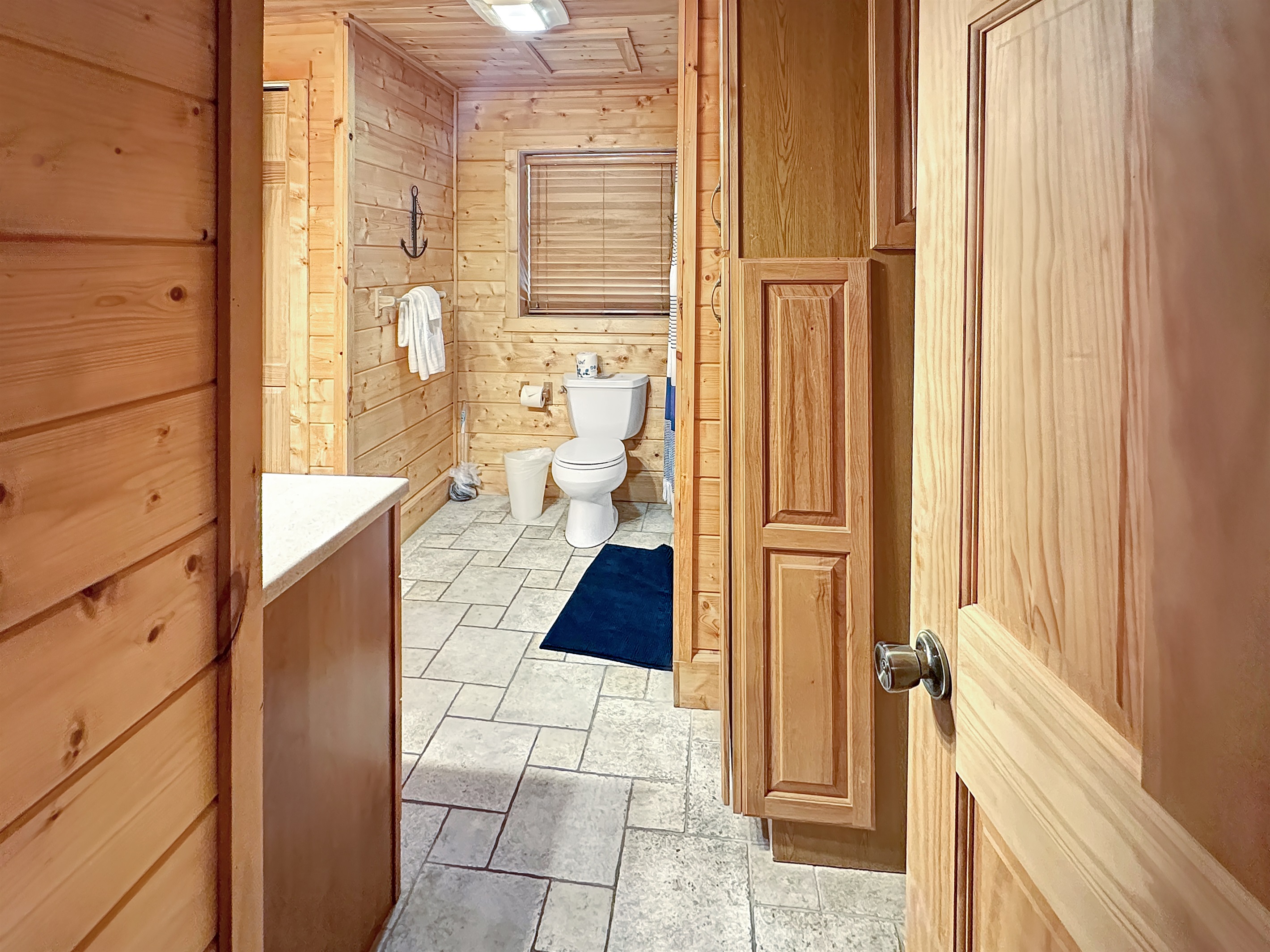 Bathroom 1: Enjoy rustic charm and modern amenities in this inviting bathroom oasis!