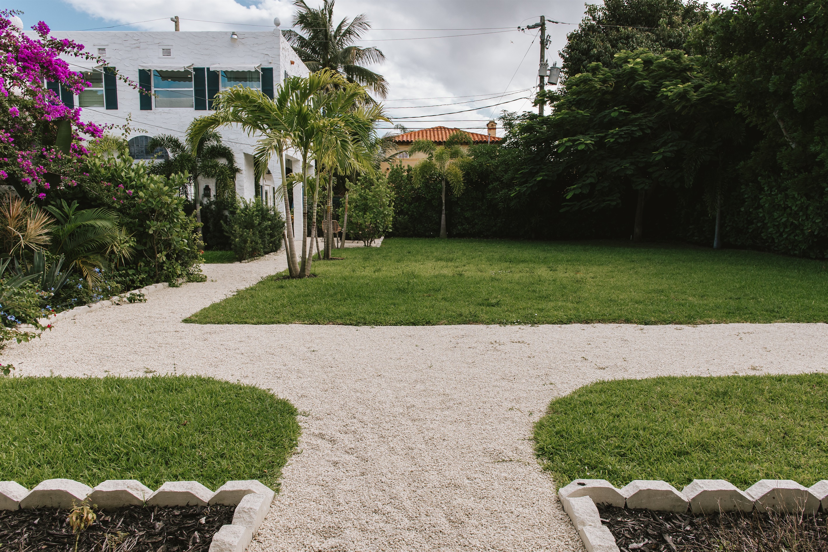 The garden of The Marisol features a spacious lawn, a walking path, hand-selected plantings and cozy, relaxing seating areas to take in the full beauty of the grounds.