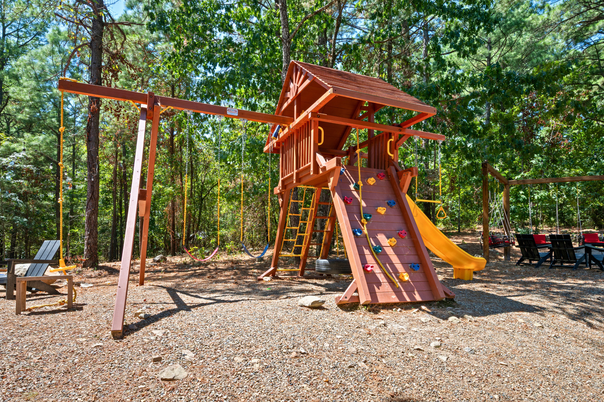 The playset gives the kids another fun place to explore outside, with swings and a slide tucked into the peaceful wooded surroundings.