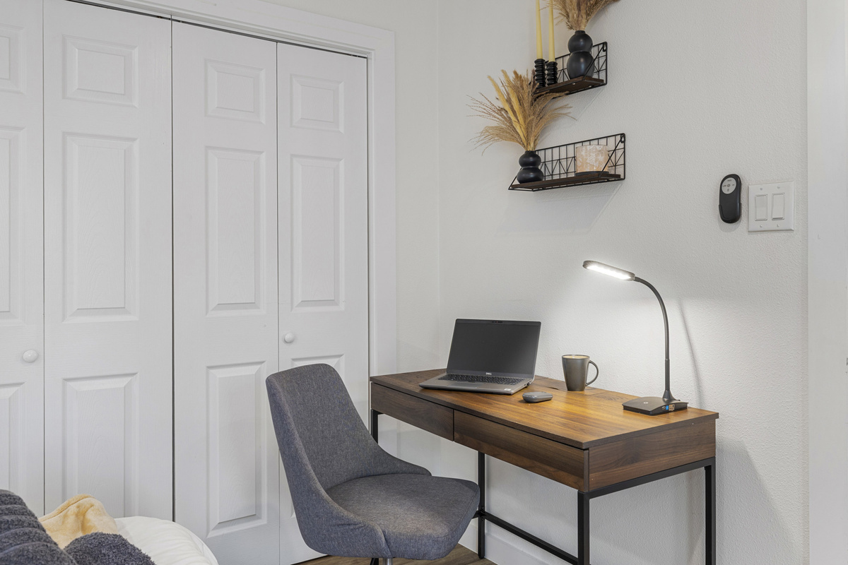 Stylish workspace perfect for remote work, complete with sleek furniture and bright lighting!