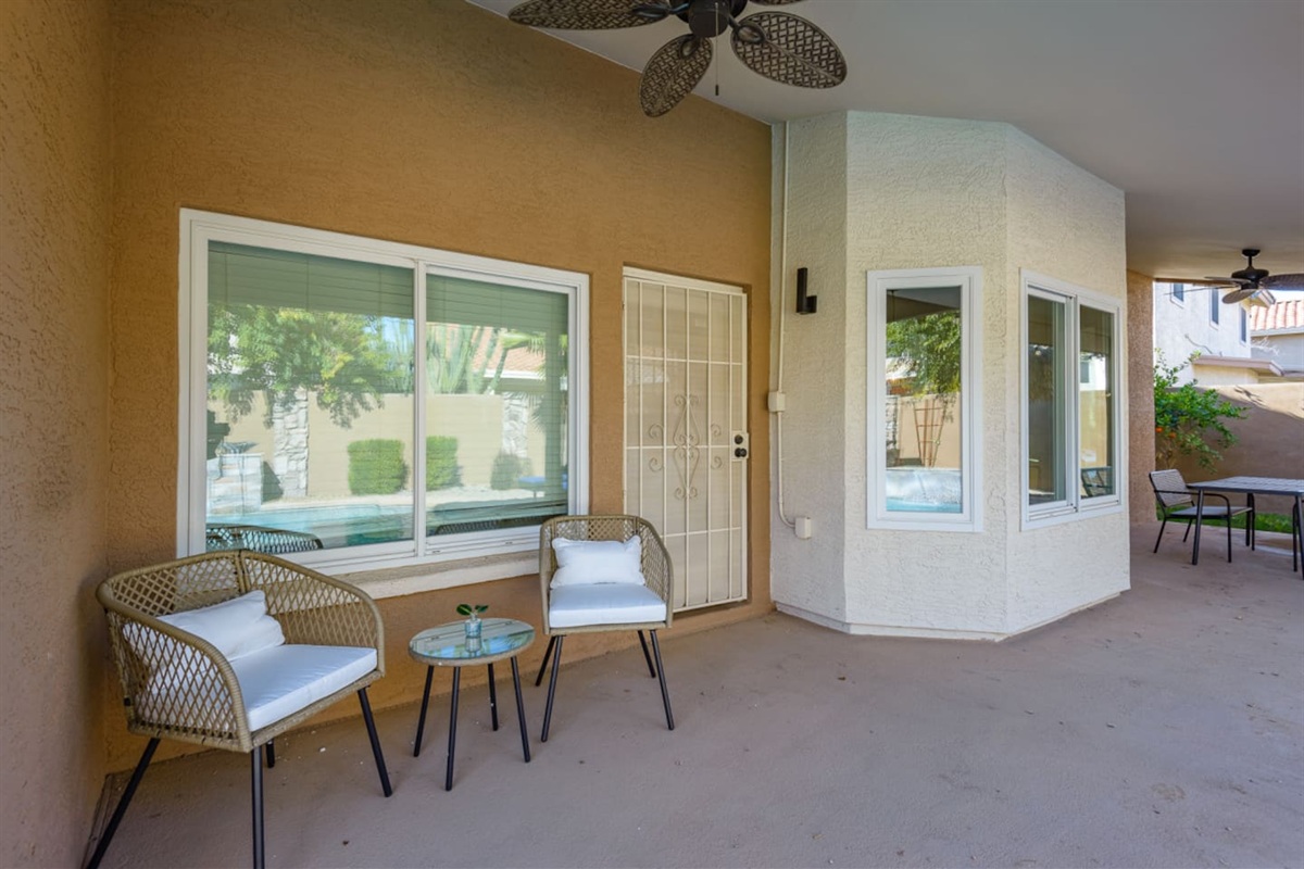 Covered outdoor seating area with window views and easy access from the home.