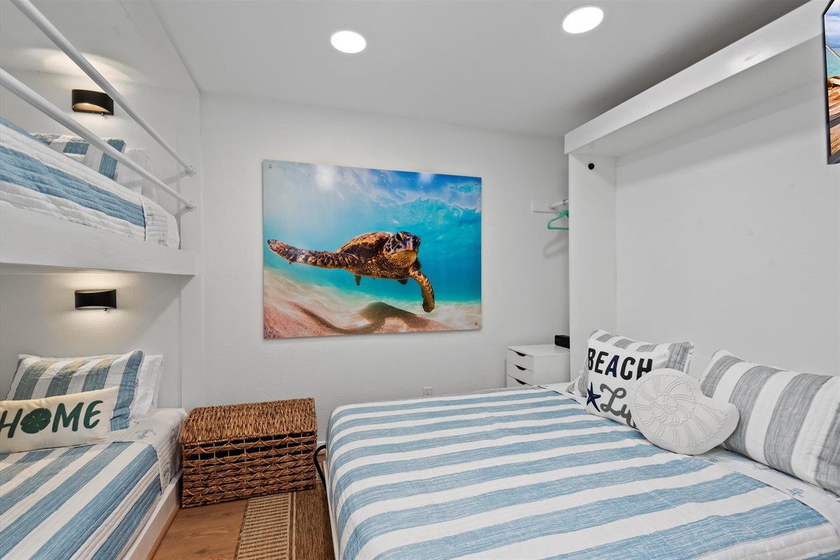In the Sea Turtle bedroom on the second floor, discover the flexibility of a custom Queen Murphy Bed combined with a built-in Twin over Twin Bunk Bed, ensuring both comfort and adaptability.