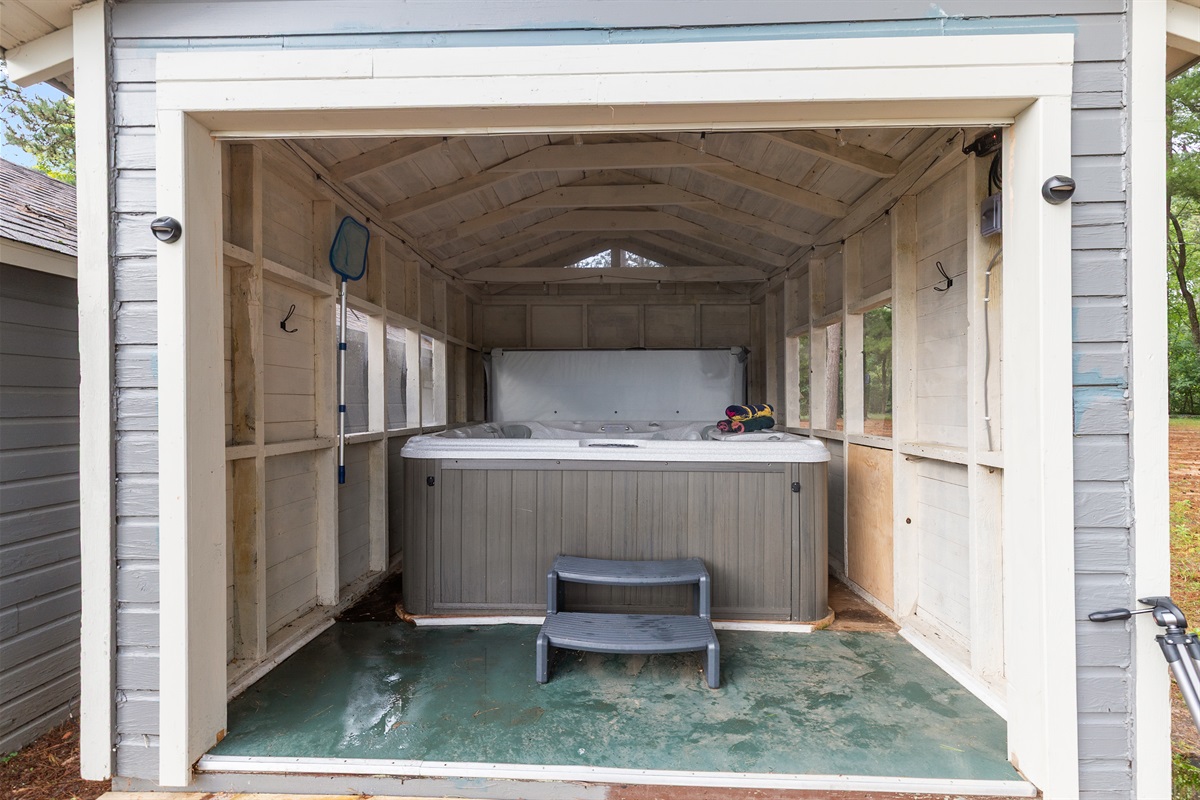 Relax in the hot tub while taking in serene views of Little Silver Lake.