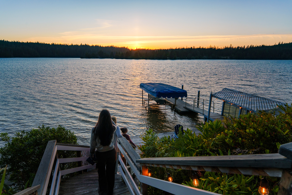 Follow the softly lit steps down to your private dock, where unforgettable sunsets over Woahink Lake set the scene for peaceful evenings by the water.