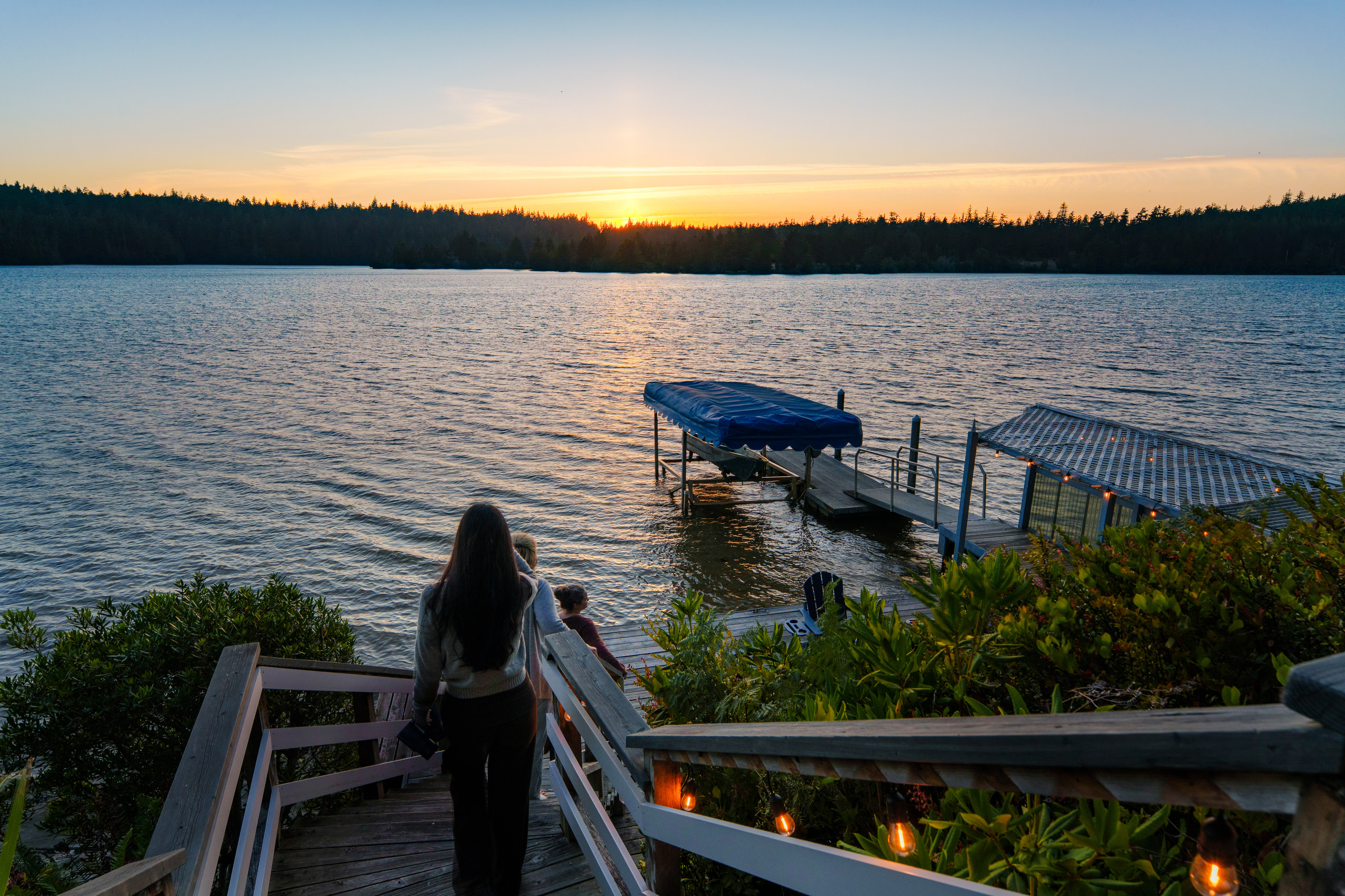 Follow the softly lit steps down to your private dock, where unforgettable sunsets over Woahink Lake set the scene for peaceful evenings by the water.