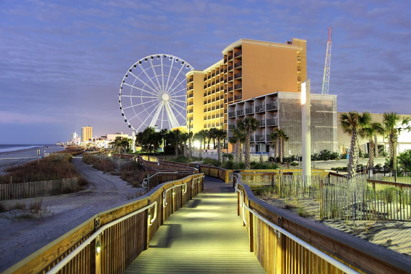 Scenic Boardwalk: Stroll along the lit pathway to breathtaking ocean views and the Ferris wheel!