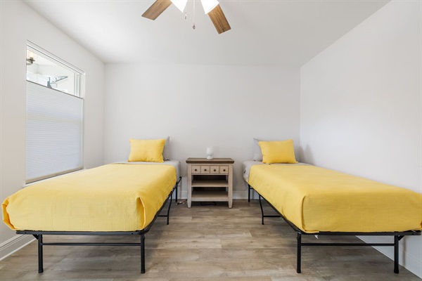 This is the 2nd bedroom which looks out onto the front porch and has a dedicated kids' play area.  It has two twin beds. This room also has a 43-inch Roku.