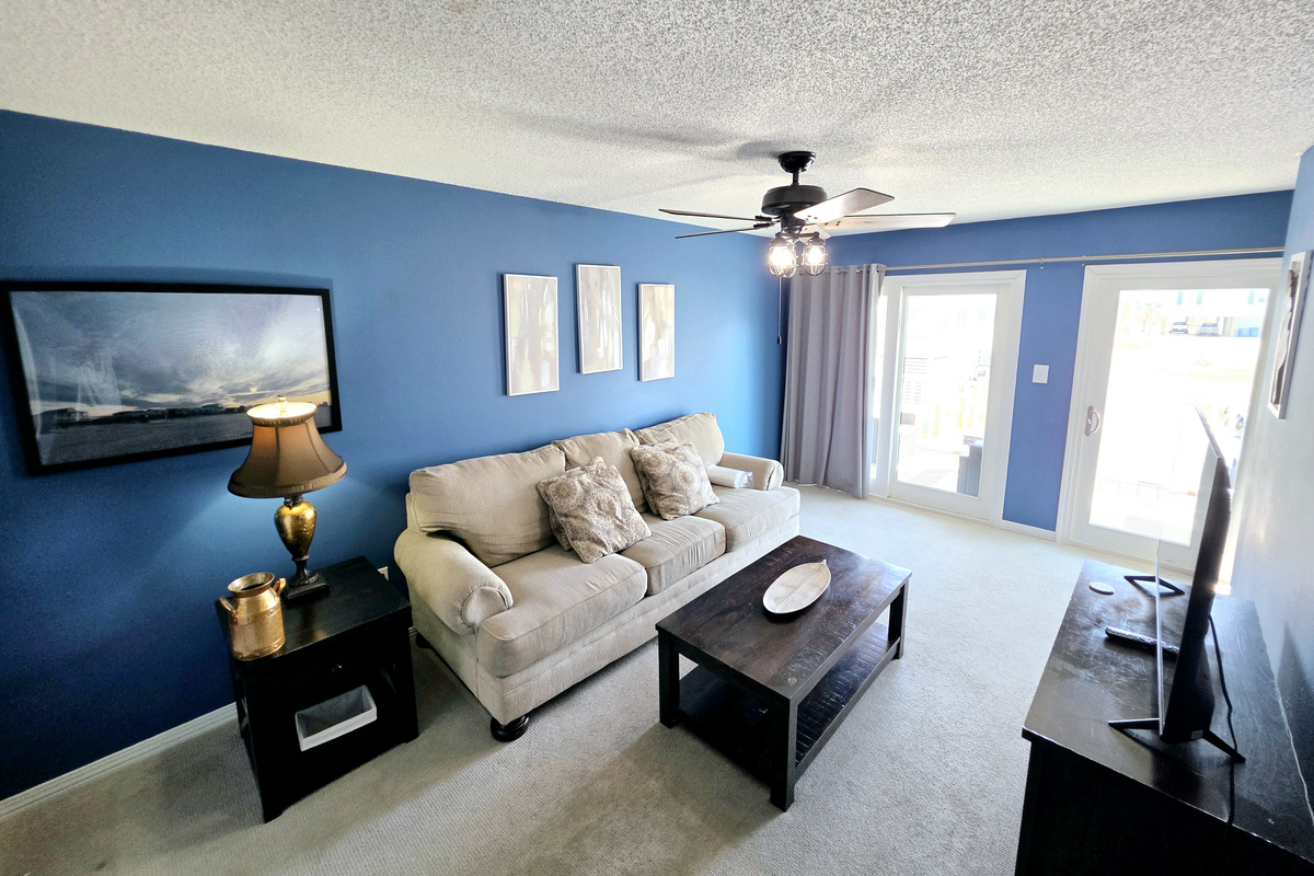 Living room with sofa and sliding door to the balcony