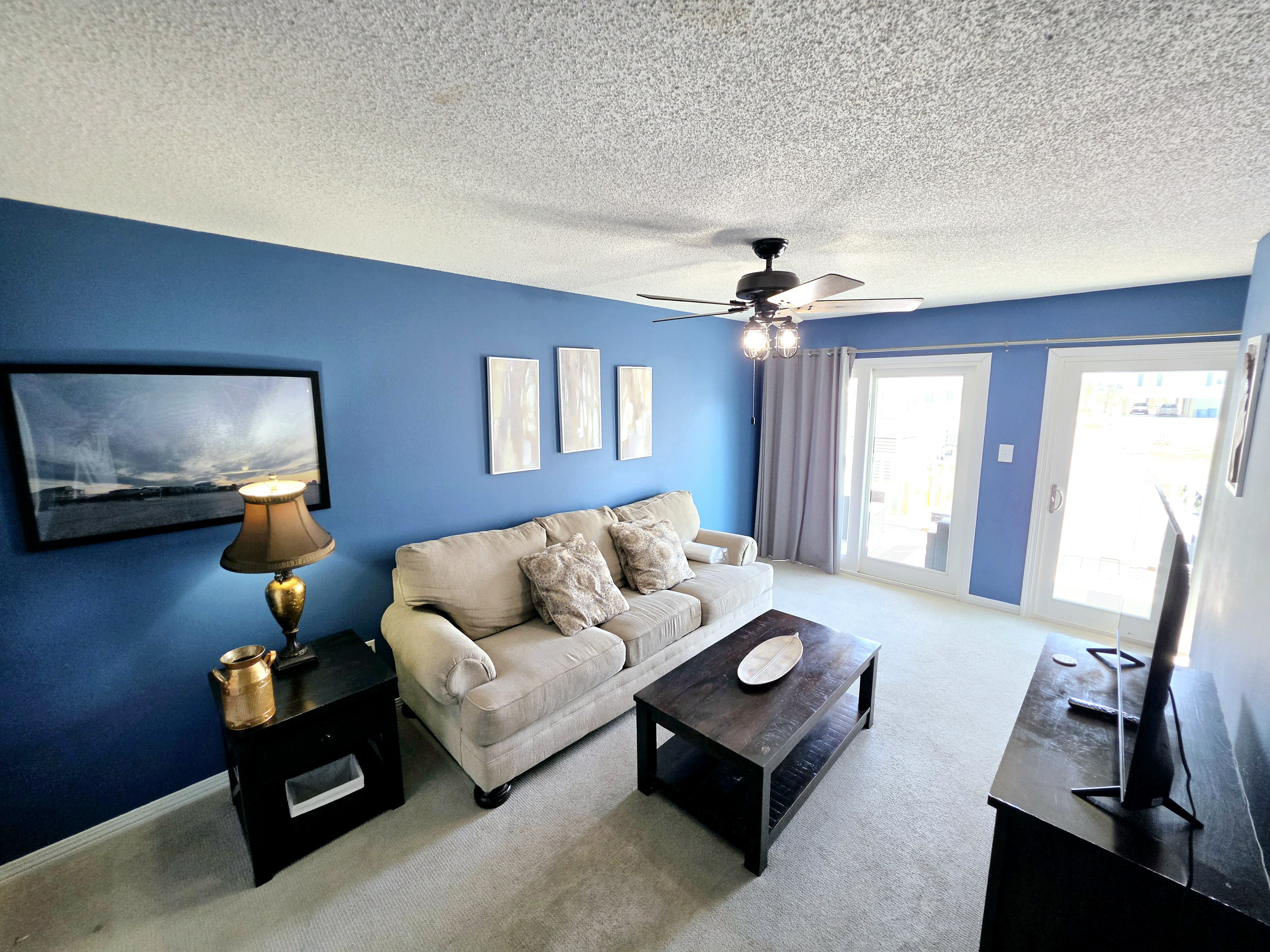 Living room with sofa and sliding door to the balcony