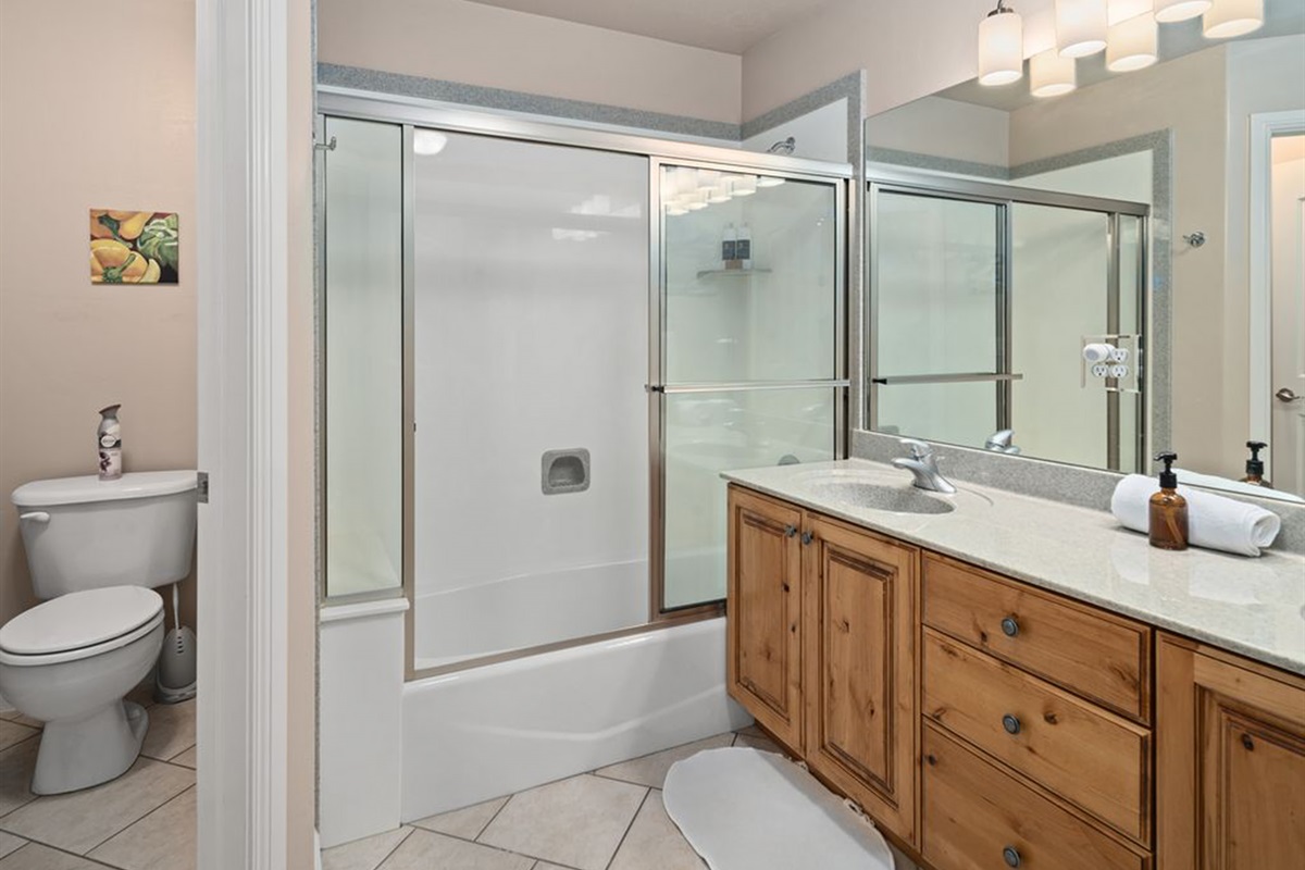 Full bathroom with double vanity and shower/tub combo—perfect for guests.