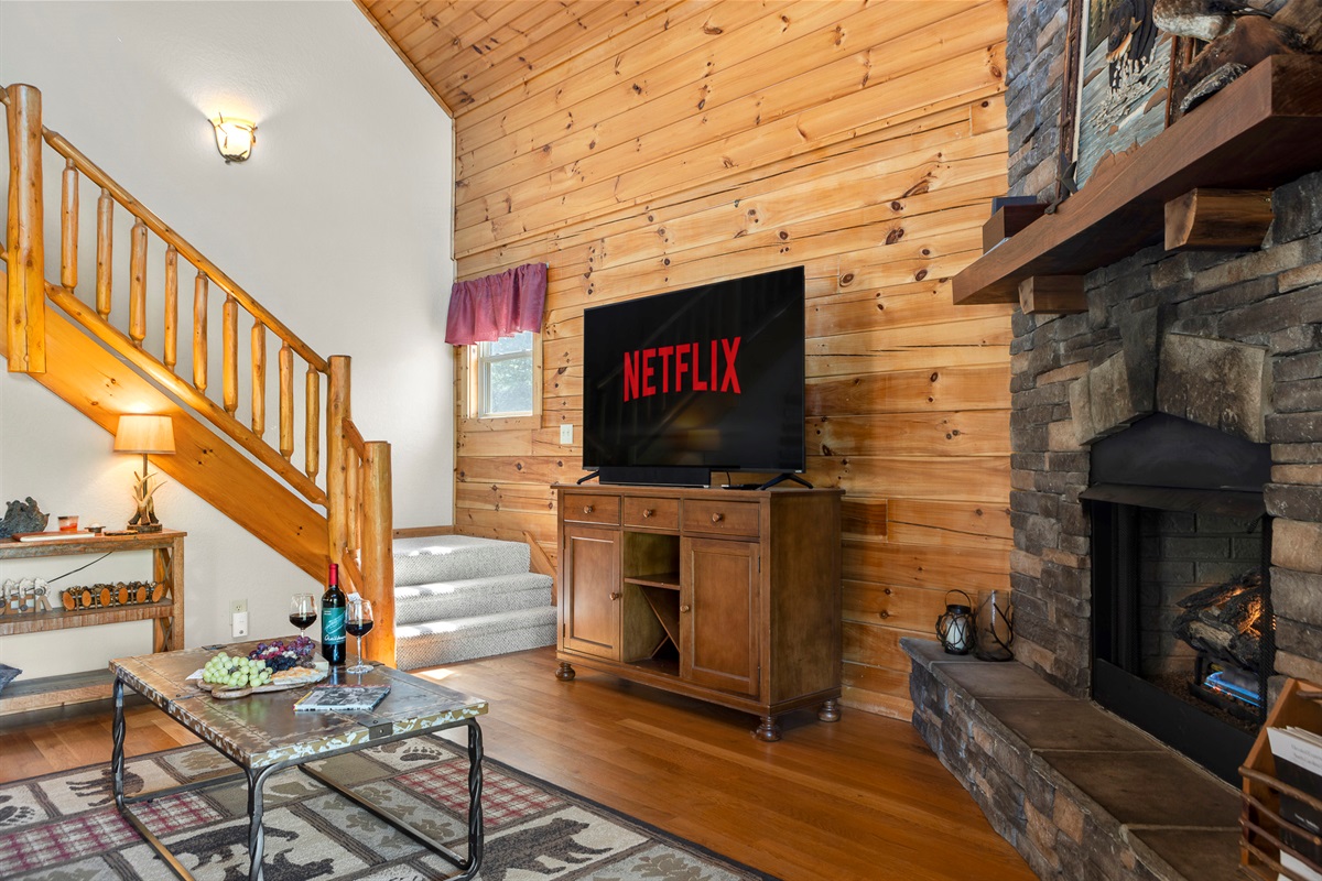 Living Room: Unwind with Netflix by the stone fireplace and enjoy mountain views from the windows!

