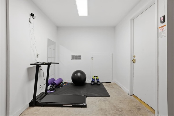 Dedicated fitness space with treadmill, dumbbells, yoga mat, resistance bands, and stability ball — enjoy the convenience of working out privately without leaving the home.
