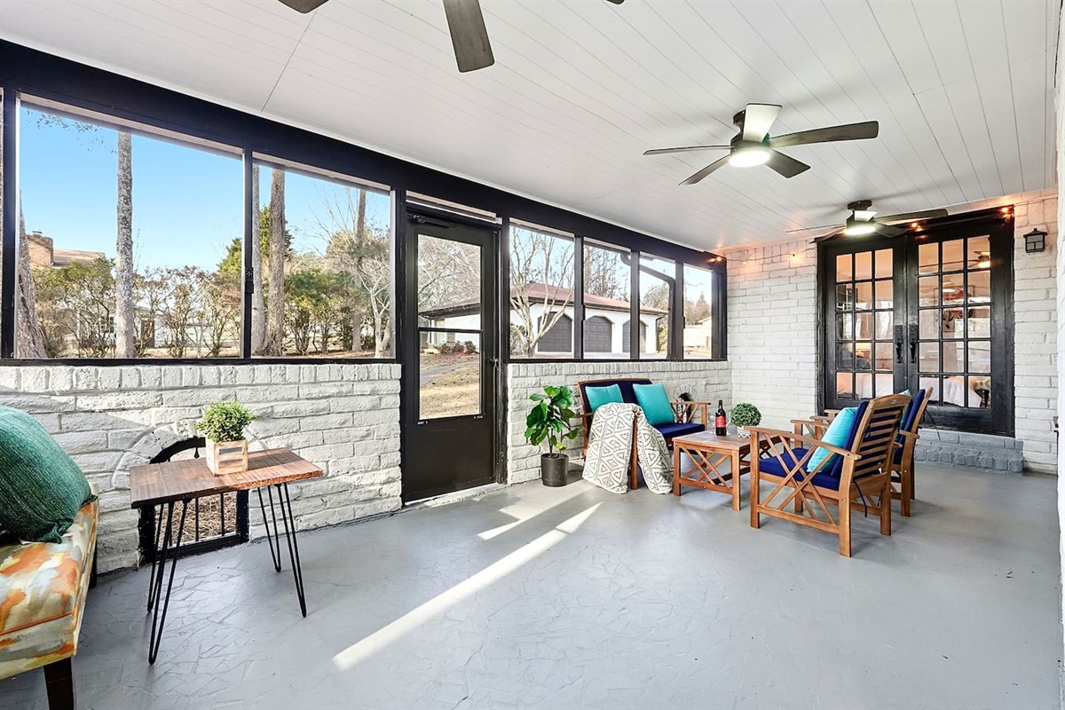 Inviting and spacious sunroom featuring ample seating, perfect for relaxing, unwinding, or spending quality time together.