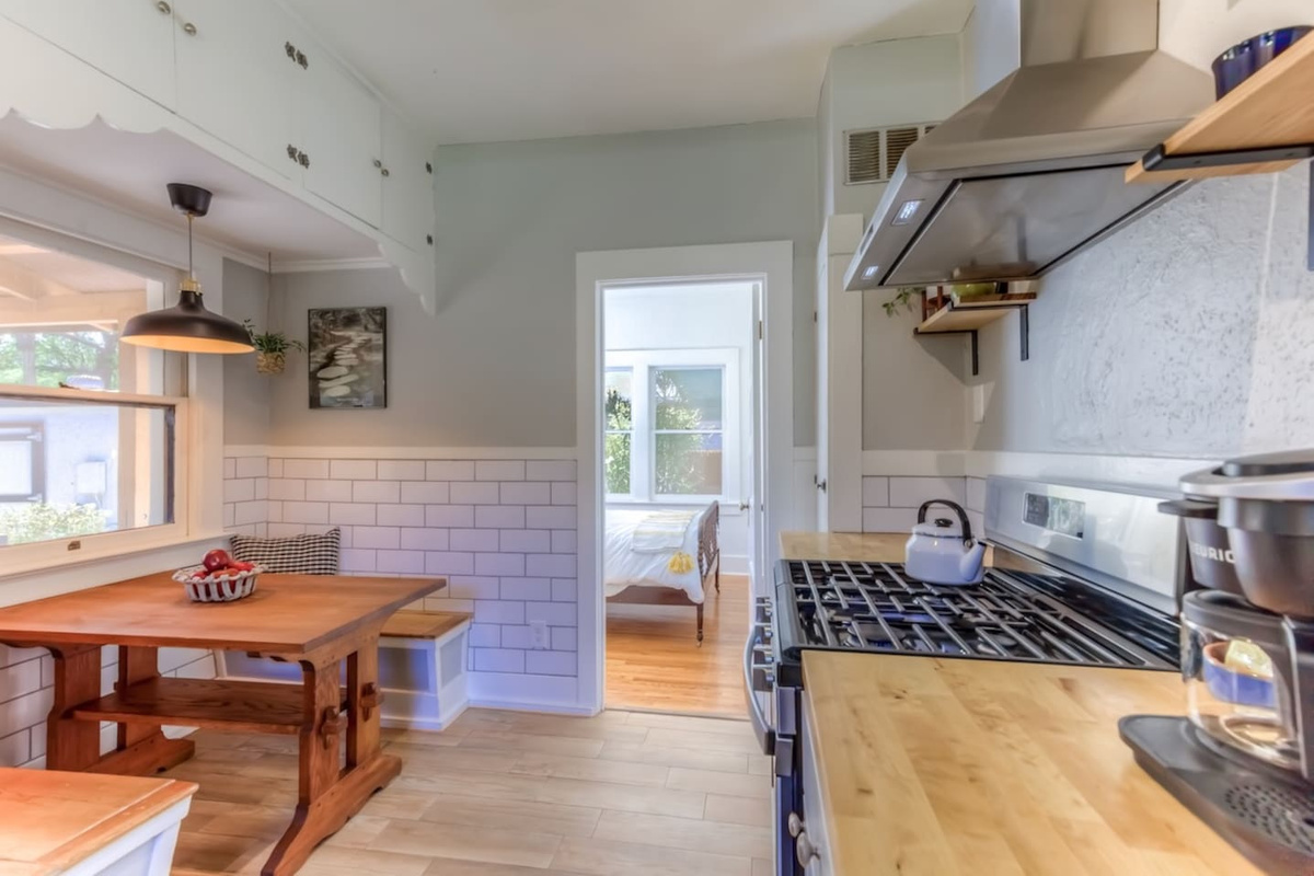 Full kitchen with breakfast nook looking onto garden