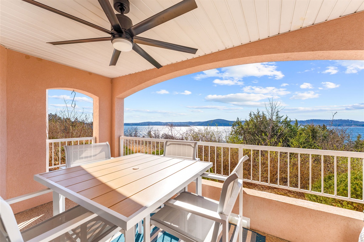 Private covered balcony with dining table.