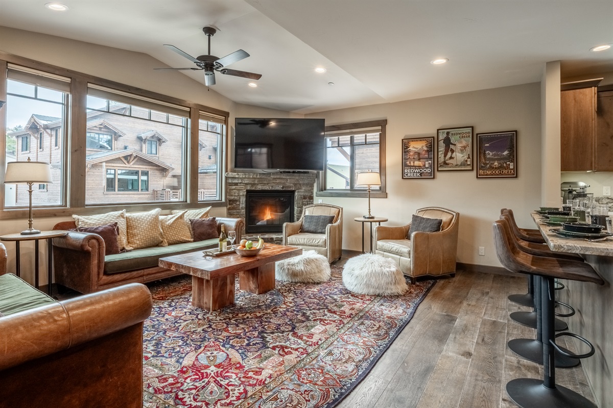 Chesterfield sofas, vintage Persian rugs, and custom local photography create a collected, intentional space—refined without feeling formal.