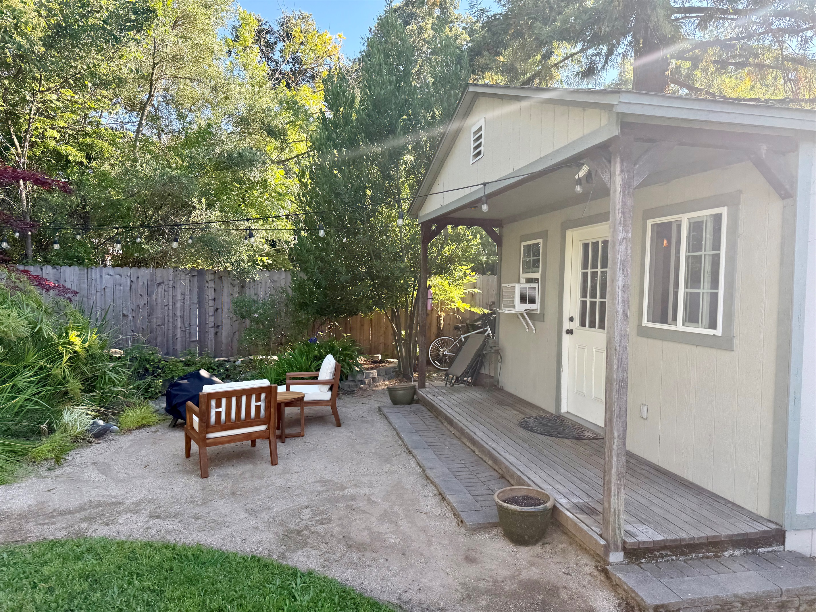 Sunlit side patio w/ easy outdoor seating for morning coffee