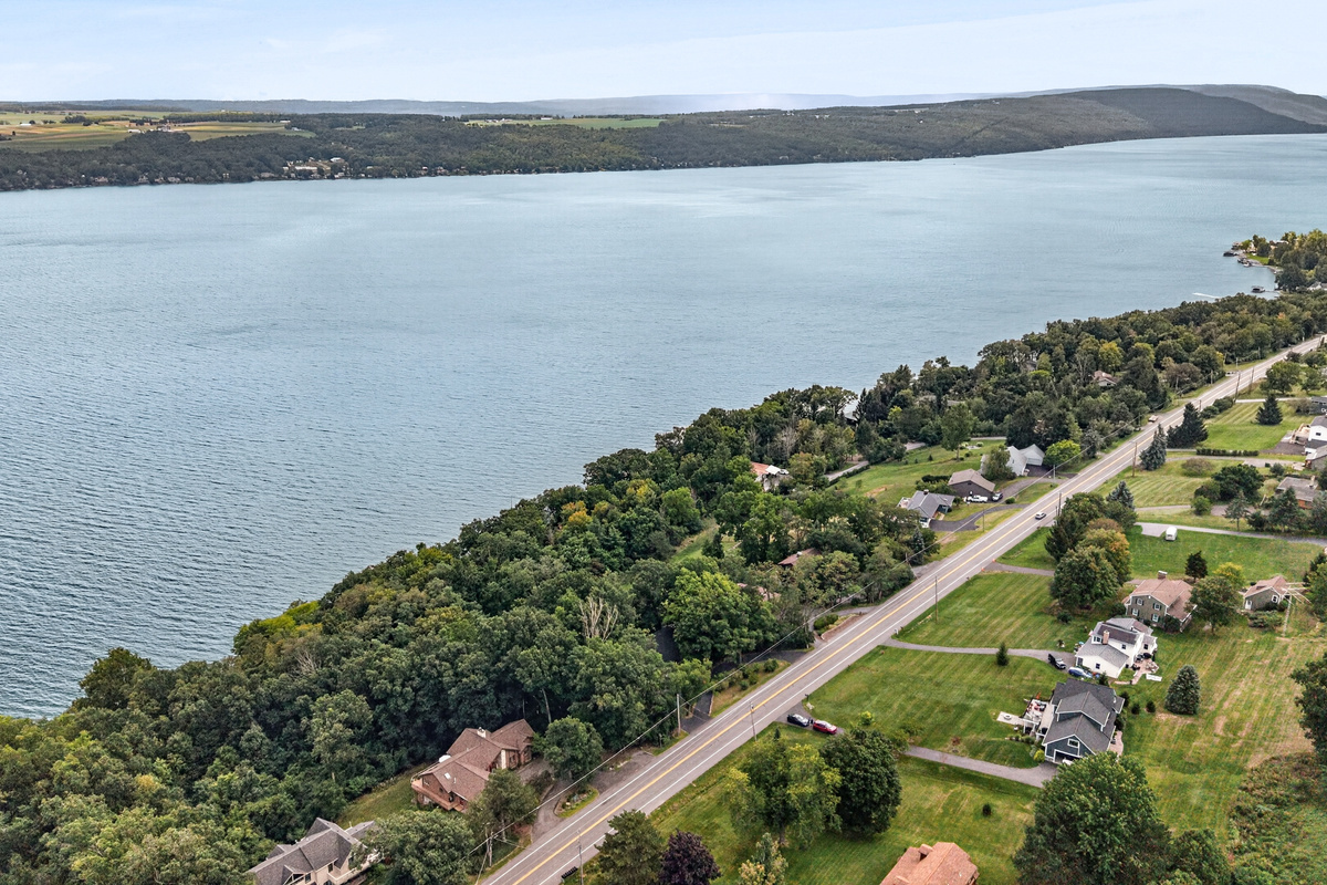 Lakeside road following the wooded shoreline