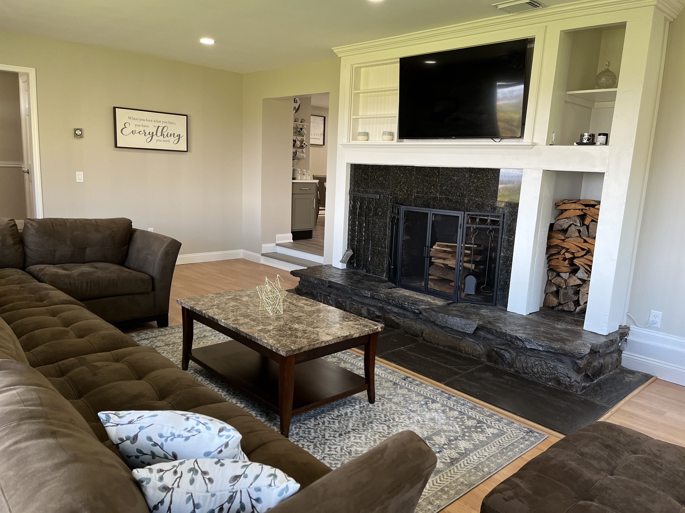 Hilltop Hideaway living room with decorative fireplace and large smart TV.