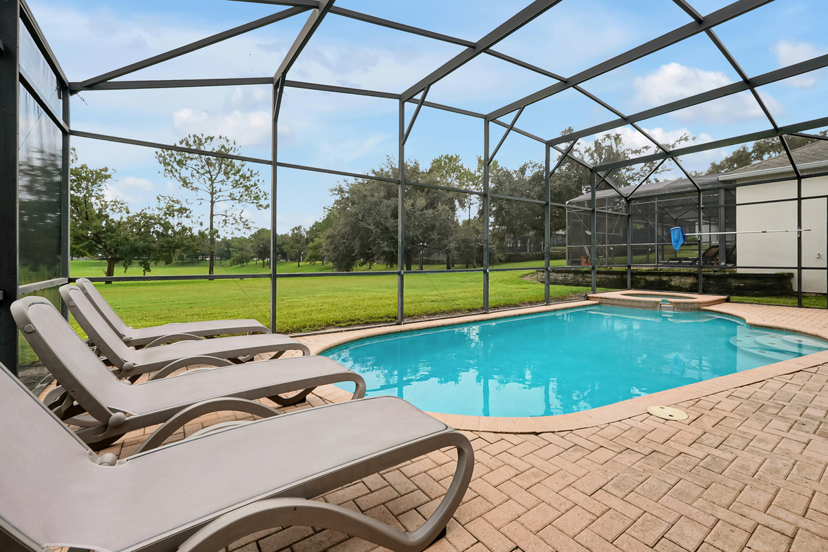 Pool loungers in screened lanai