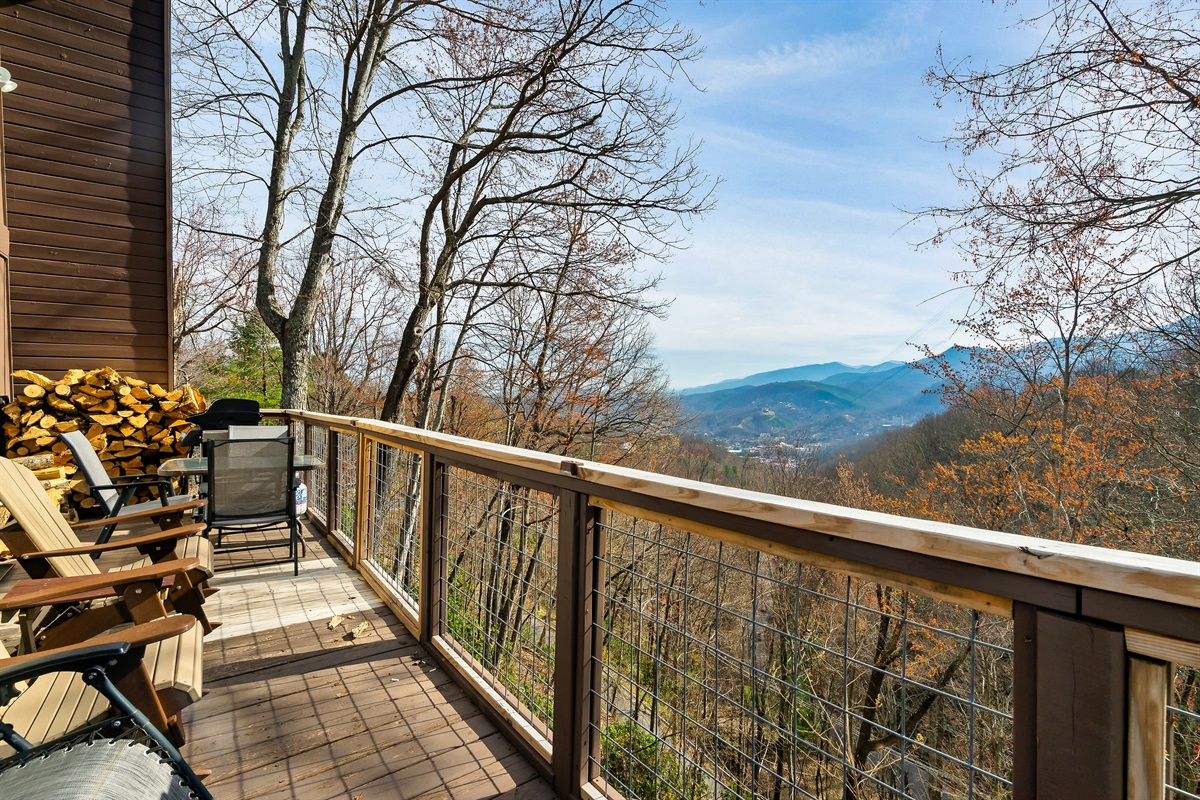 Main level deck with outdoor sitting area and gas grill