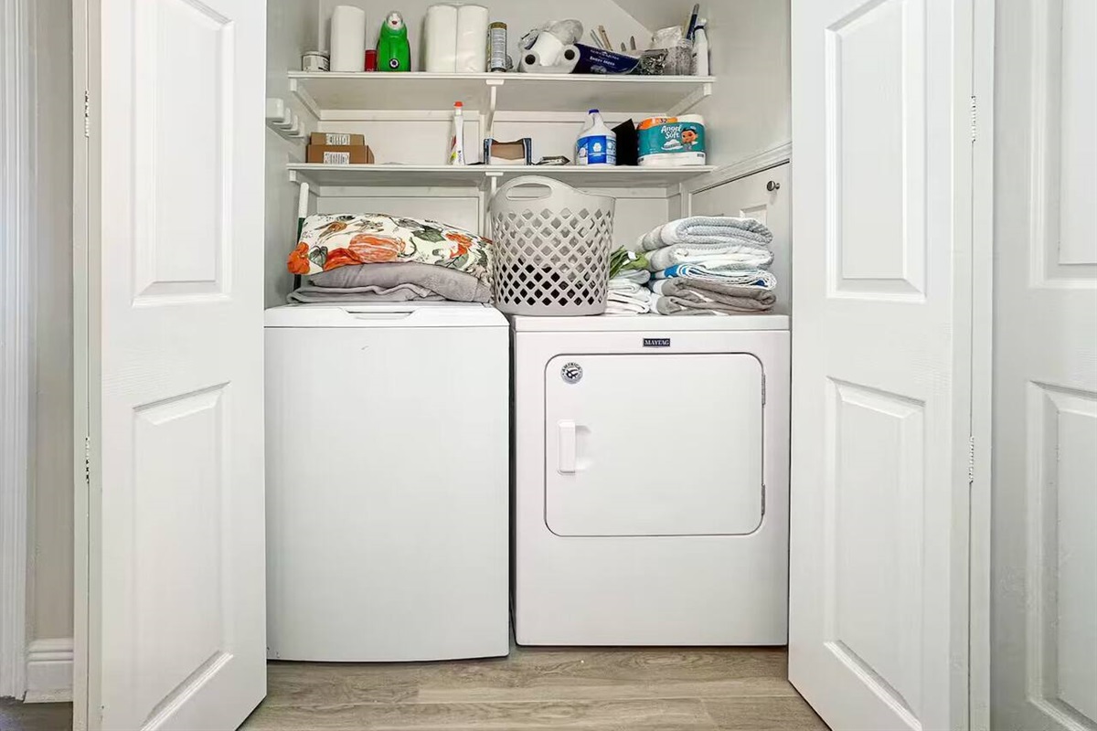 Convenient laundry area featuring a washer, dryer, and organized storage—perfect for longer stays.