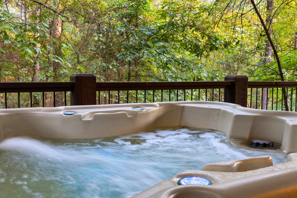 Relax in the bubbling hot tub surrounded by tall trees and tranquil sounds of nature.