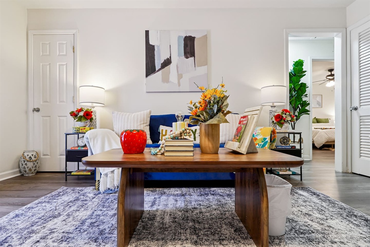 The living room features cozy furniture, including a comfortable blue couch, and an Amazon Fire-powered Smart TV for your entertainment. You’ll also find the Xfinity modem conveniently located here, convenient for ethernet connection.