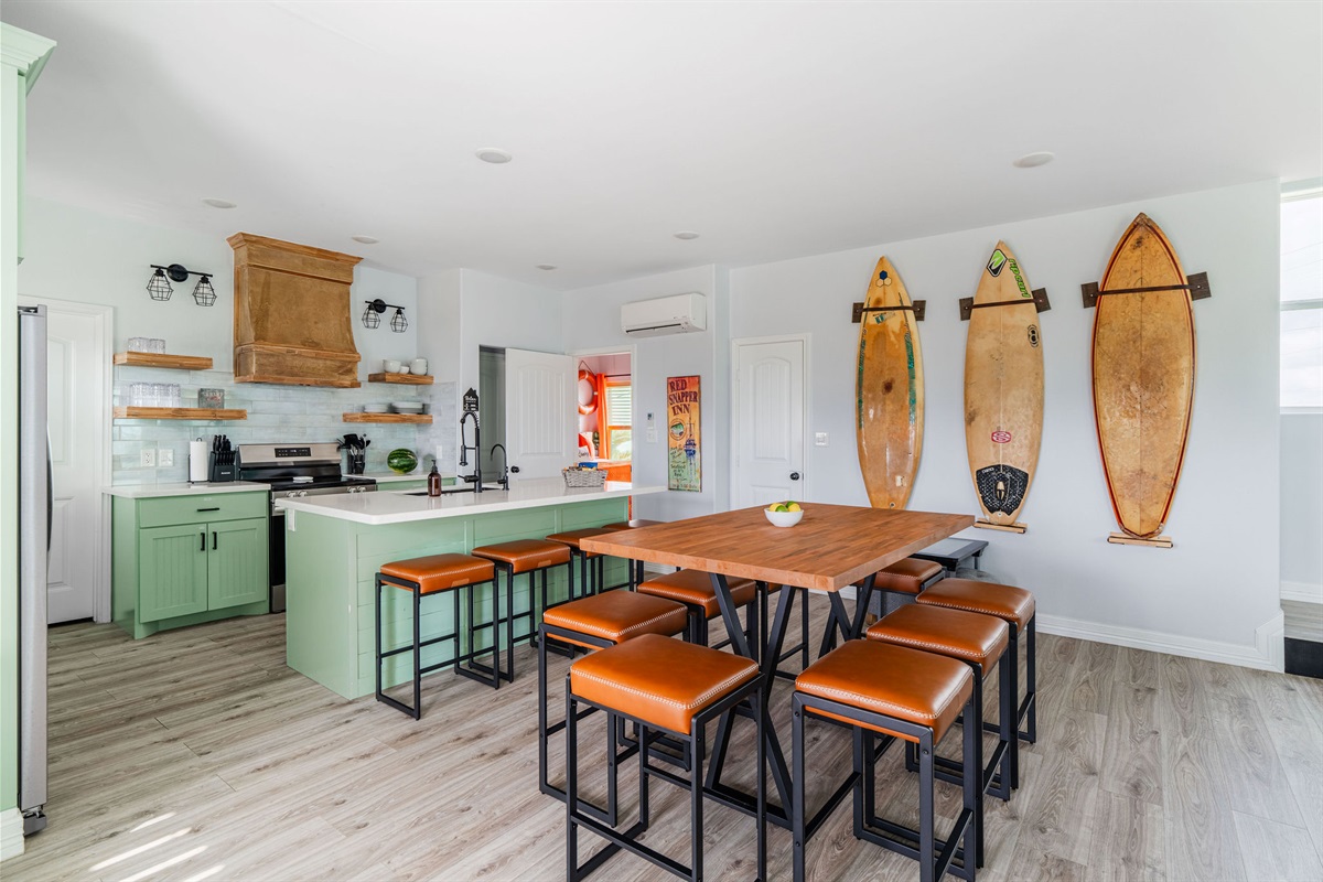 Full refreshed kitchen with surfboard wall. Dining for 10 + 3 bar stools. Cook shrimp boils, host taco night, feed the crew.