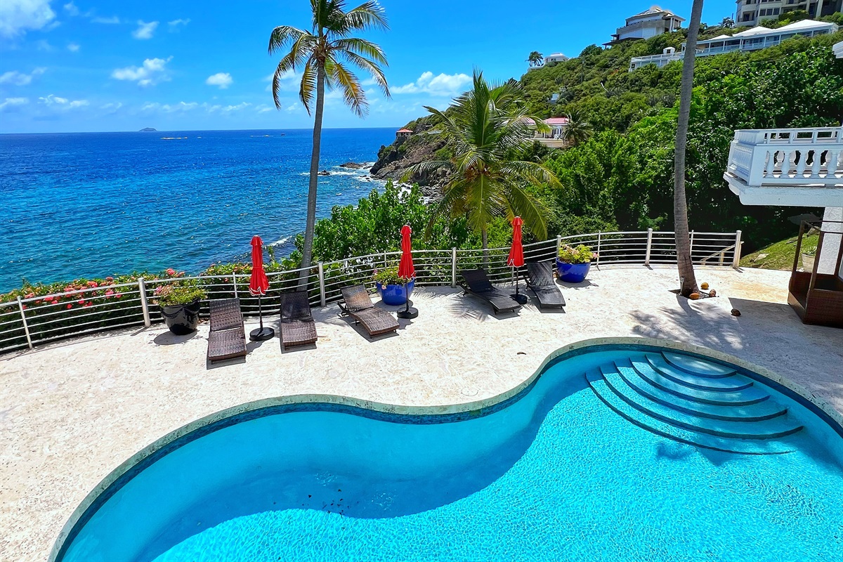 Lounge by the pool with breathtaking island scenery all around.