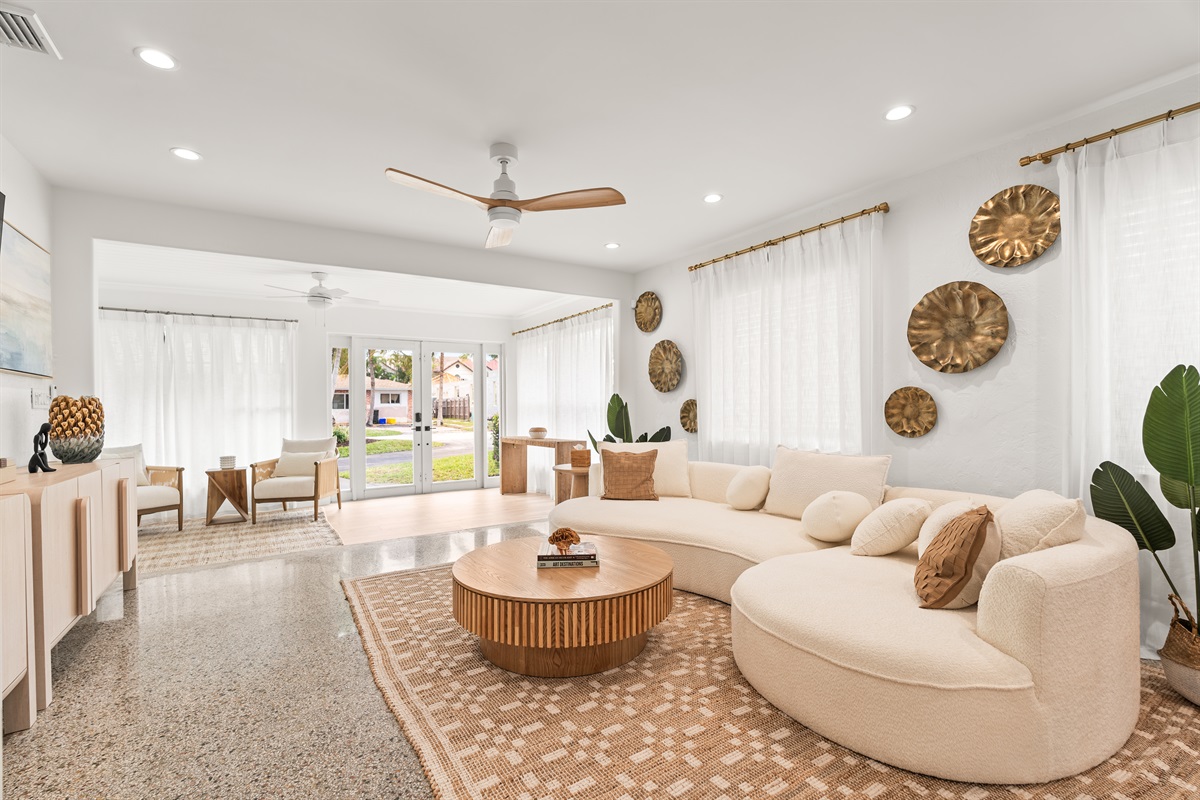 Gather, lounge, repeat. This sun-filled living area flows seamlessly into the kitchen and dining space for easy vacation living.