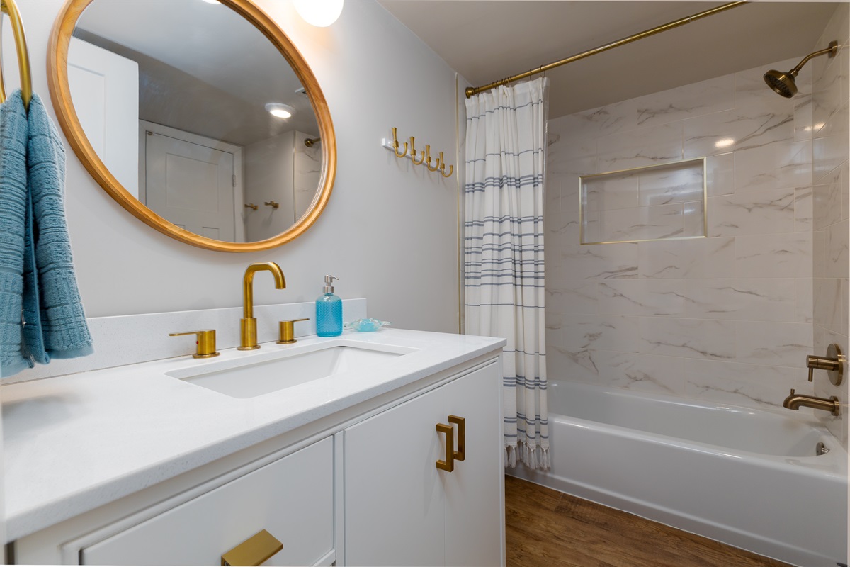 White vanity and bathtub offer a spa-like feel