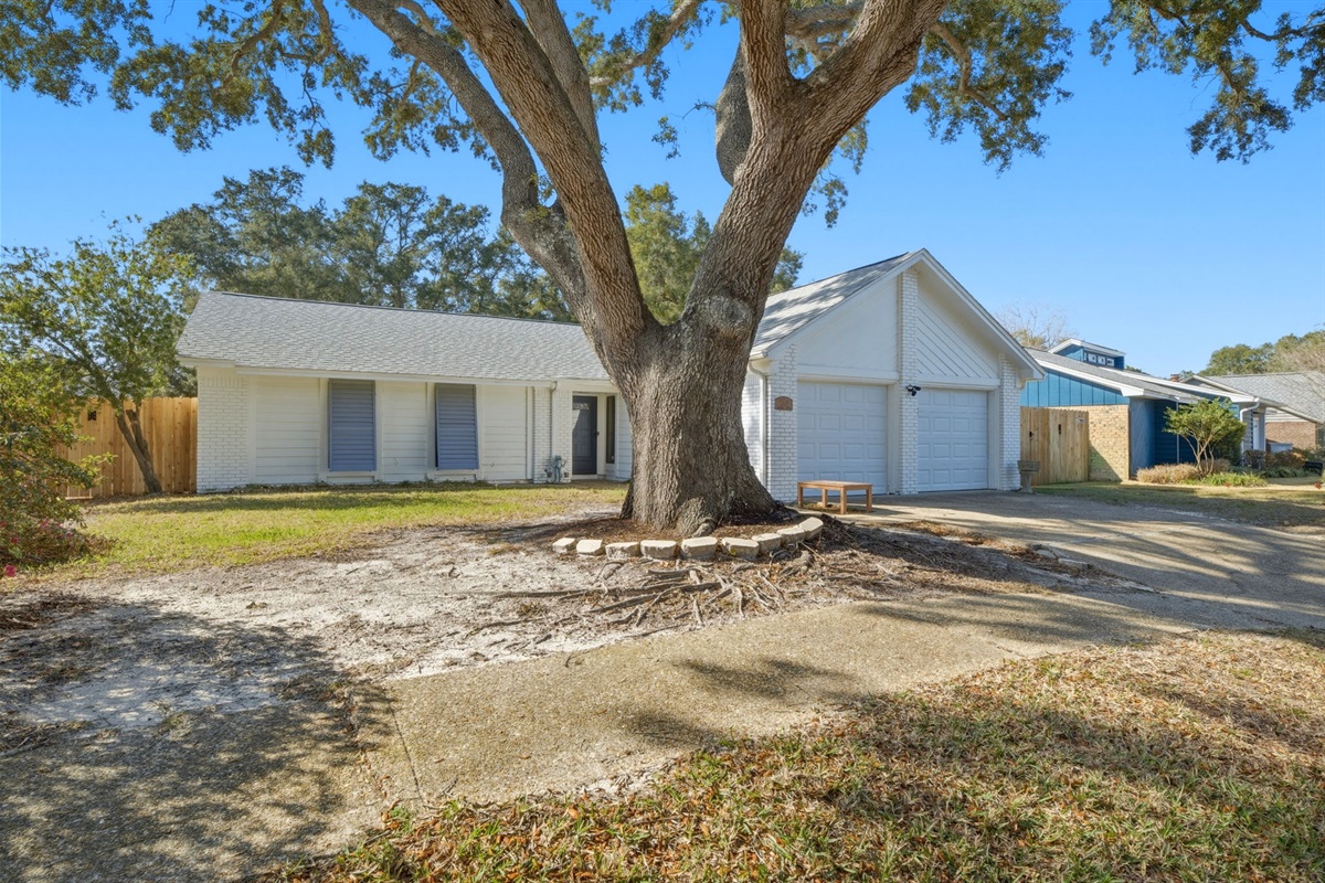 This charming home welcomes you with a beautiful mature oak tree that provides natural shade and character to the front yard. The spacious driveway and two-car garage offer plenty of parking, while the bright exterior and peaceful surroundings create a war