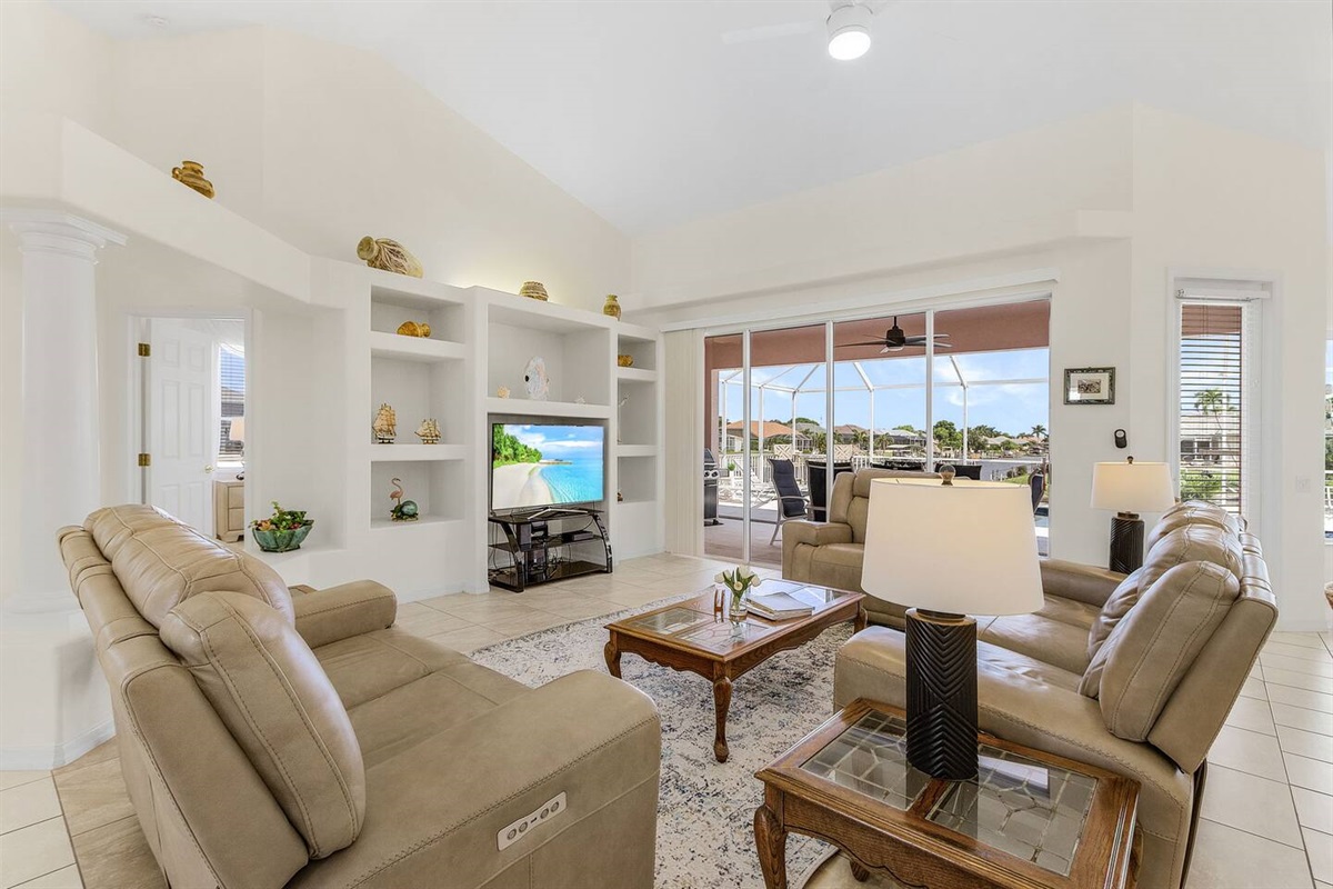 Relax in the living room with a TV, and enjoy effortless access to the pool, spa, and lanai for ultimate indoor-outdoor living!